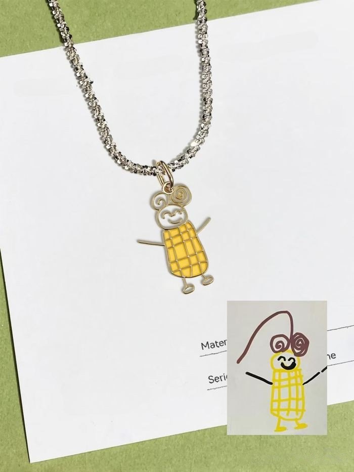 Yellow corn man drawing as an enamel pendant