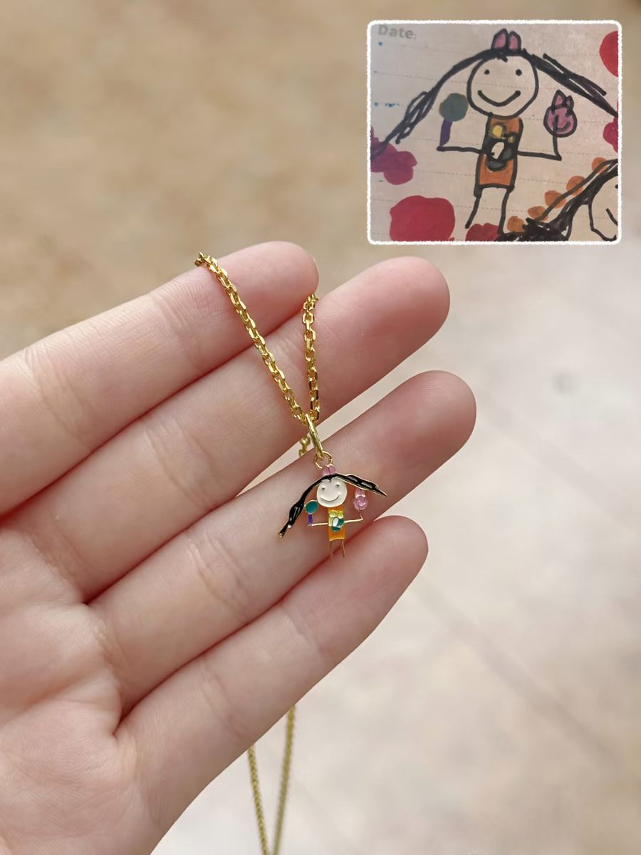 Girl's self-portrait as a small gold pendant