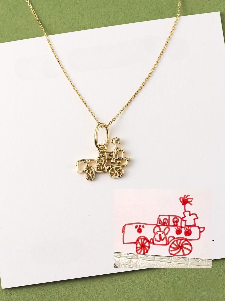 Tractor drawing as a gold outline pendant